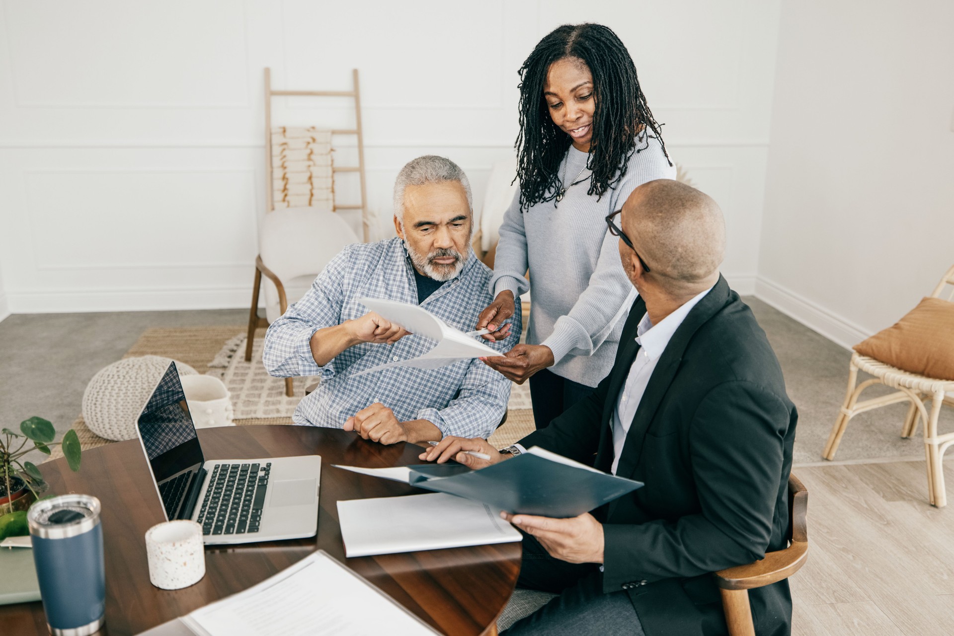 Stock photo of multi-ethnic professionals - financial advisor, mortgage broker and Real Estate Agent party